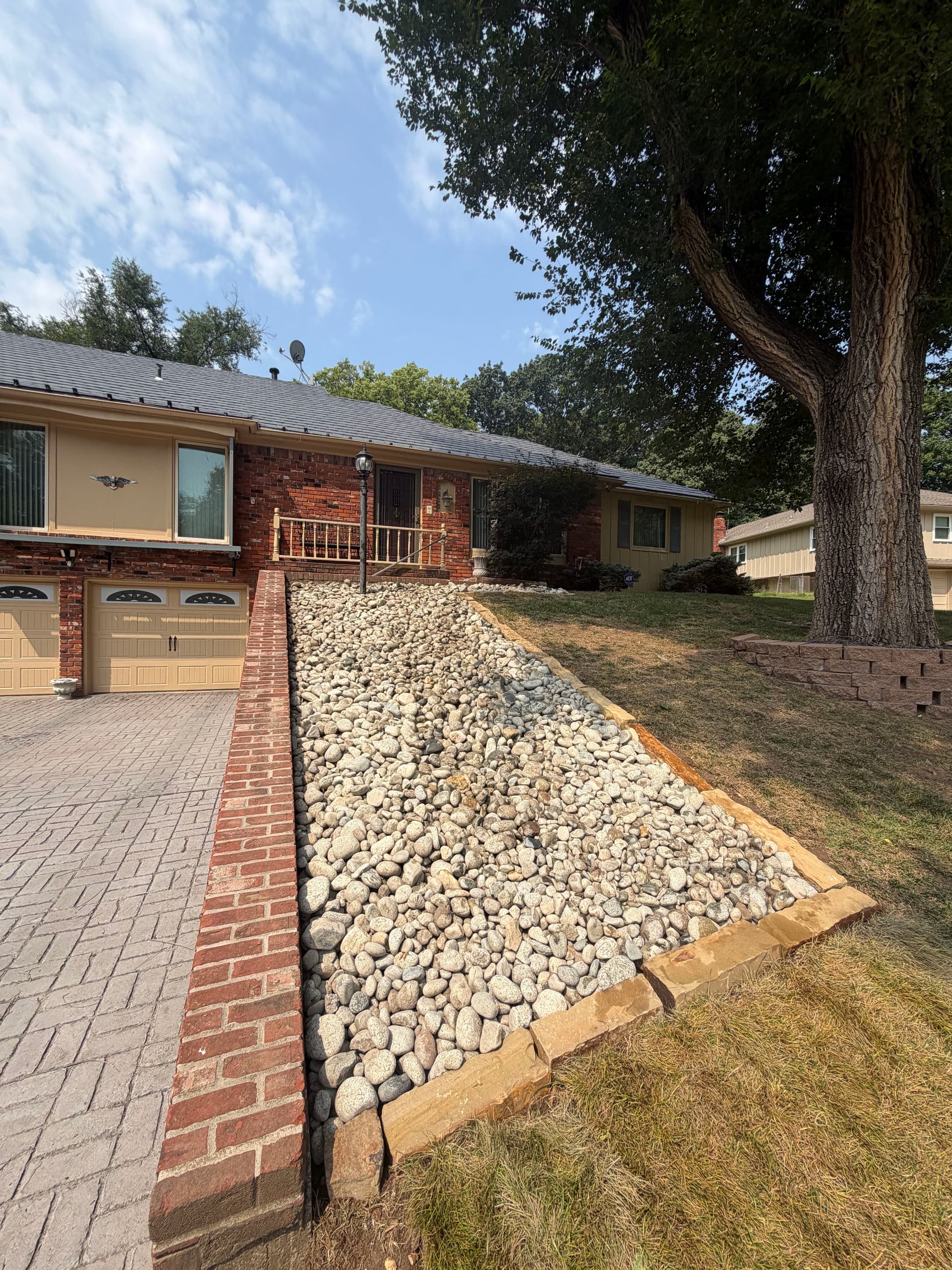 Rock Bed Installation Fixes Patchy Lawn Areas in Gladstone Missouri image