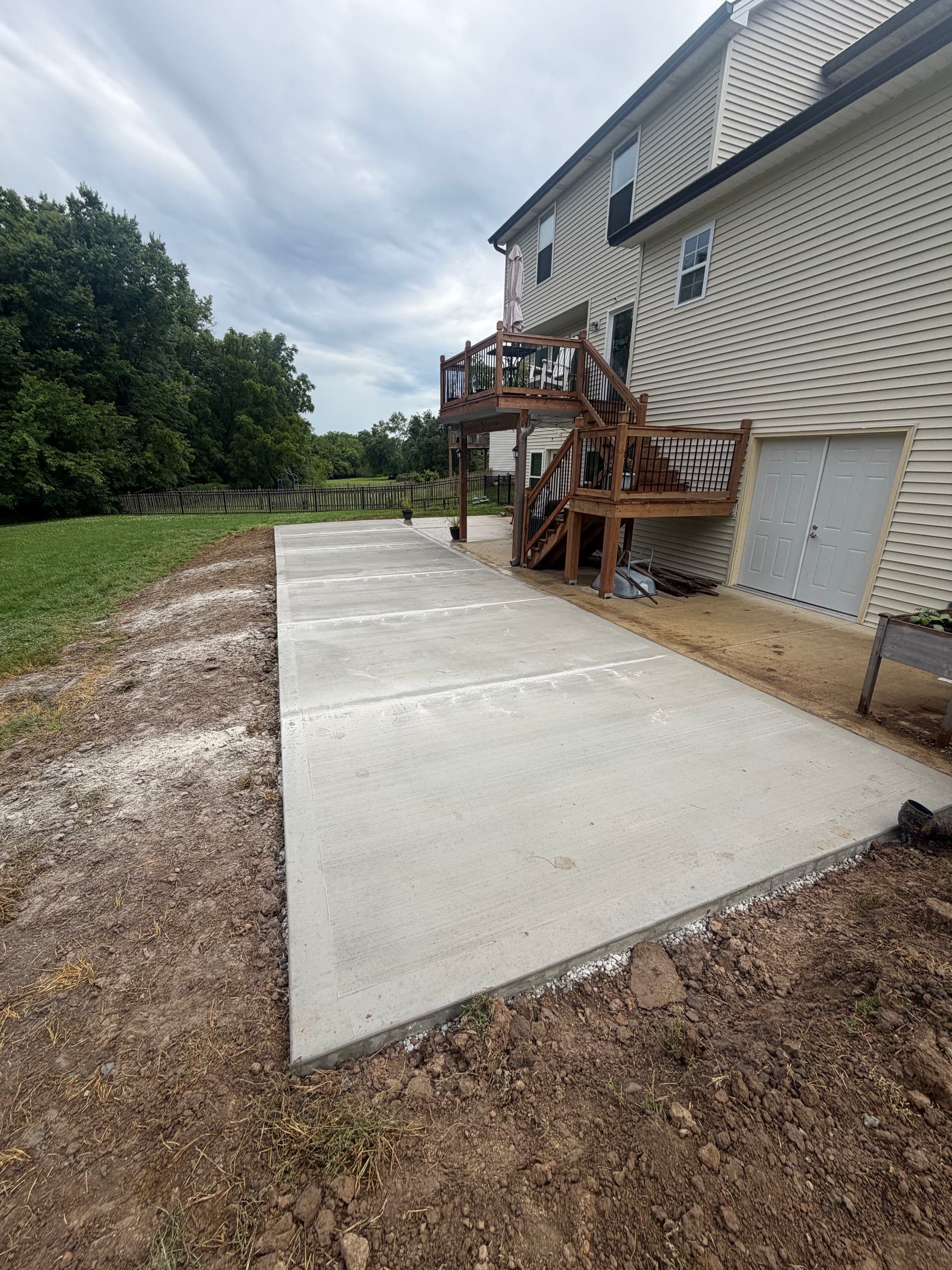 Patio Extension with Retaining Wall and Rock Bed in Platte City