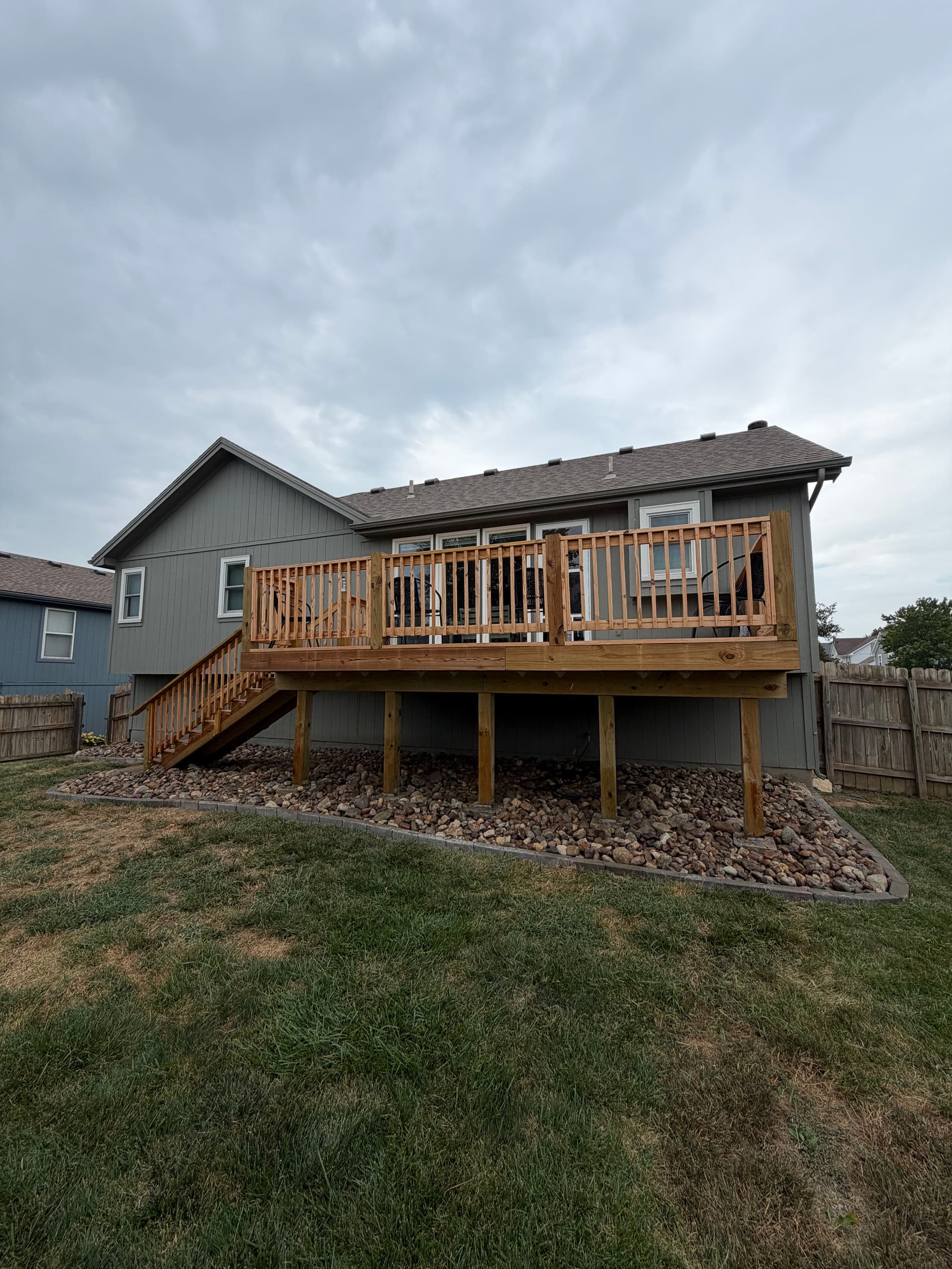 Bullet Edging and Rock Beds Give This Smithville Backyard a Finished Look image